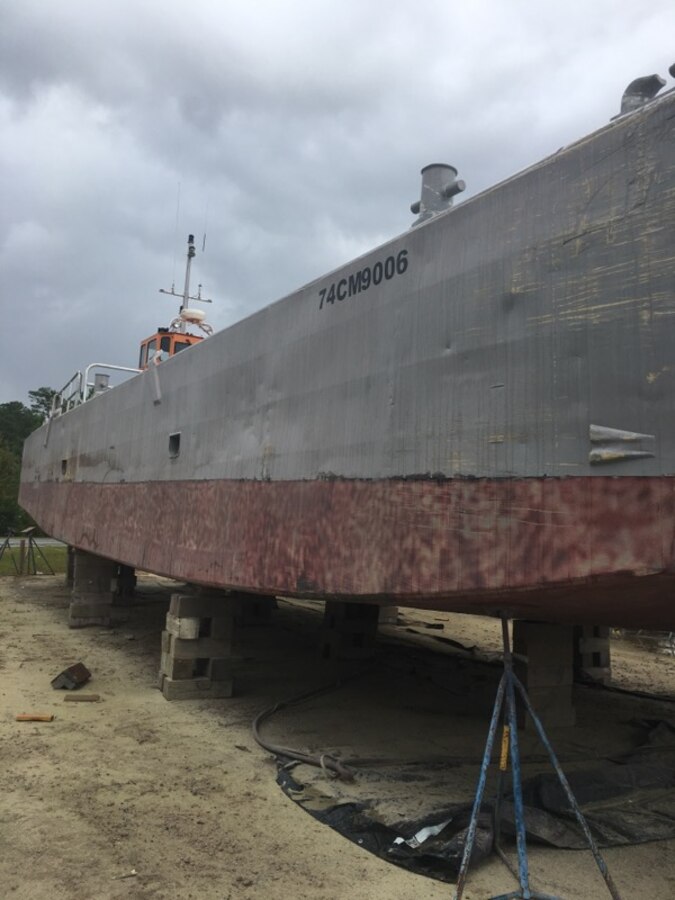 “Oscar,” a 75-foot Landing Craft Mechanized ship operated by U.S. Navy Sailors assigned to the Navy Boat Docks at Marine Corps Air Station Cherry Point, N.C., rests on blocks before undergoing maintenance, Oct. 10, 2018. The Sailors took Oscar to a commercial boat yard near Beaufort, N.C., to conduct maintenance on it due to MCAS Cherry Point not having a lift big enough to hoist the ship out of the water. In addition to the scheduled annual maintenance on Oscar, the Sailors also conduct annual maintenance on five other naval vessels to maintain readiness throughout the year. (Courtesy photo by U.S. Navy Petty Officer 1st Class Francisco Galvan)