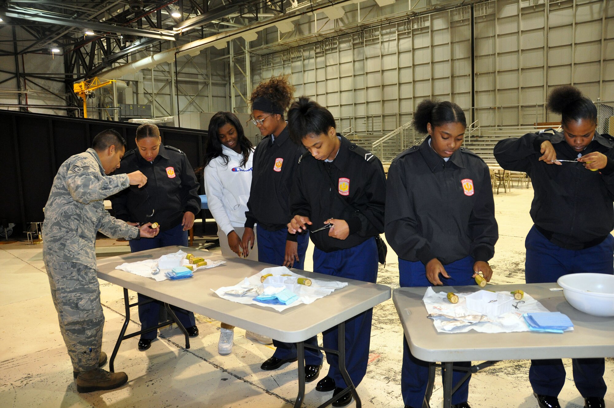 Tech. Sgt. Christian De La Cruz, 445th Aeromedical Evacuation Squadron, teaches suturing techniques to students from Meadowdale High School during the Dayton public schools outreach event Oct. 18, 2018.