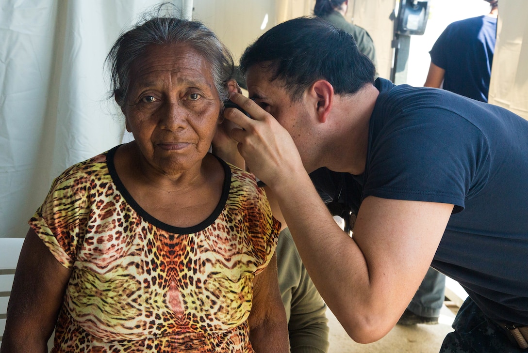 Lt. Daniel Naranjo checks the ears of a patient at one of two medical sites.