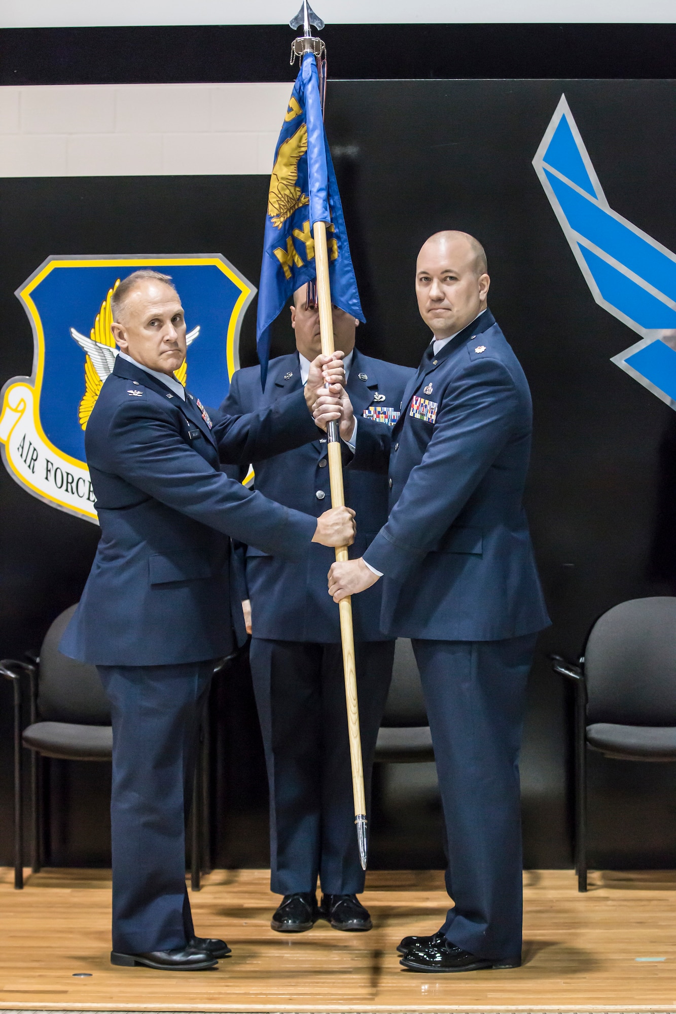 Col. Jay Smeltzer, 445th Maintenance Group commander, passes the guidon to the incoming 445th Maintenance Squadron commander, Maj. Randolph Gantt, during the 445th MXS change of command ceremony Oct. 13, 2018.