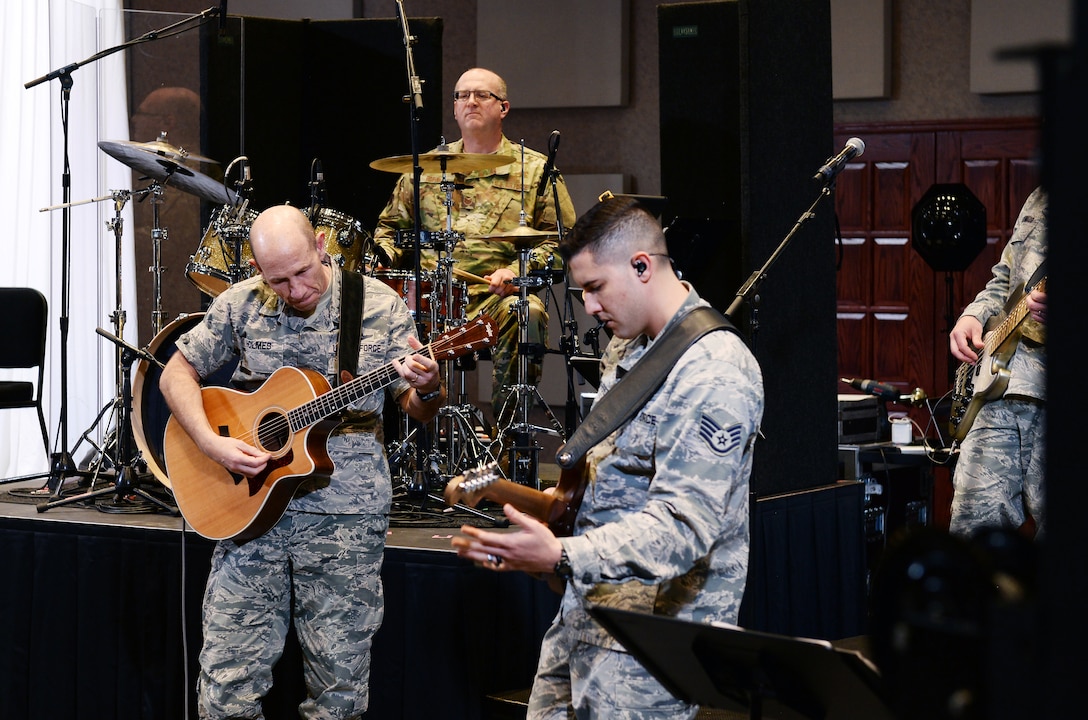 U.S. Air Force Gen. Mike Holmes, the commander of Air Combat Command, plays “Sister Golden Hair” by America Oct. 31, 2018, inside the U.S. Heartland of America Band concert hall at Offutt Air Force Base, Nebraska.