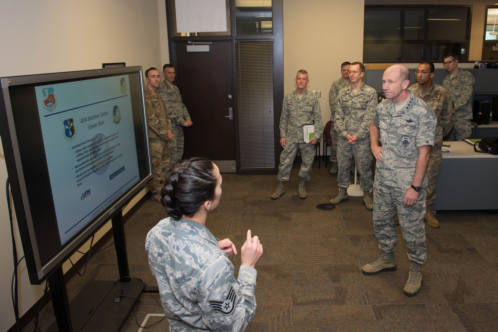U.S. Air Force Gen. Mike Holmes, the commander of Air Combat Command, receives a tour of the 2nd Weather Squadron American Forces Network Oct. 31, 2018, at Offutt Air Force Base, Nebraska.