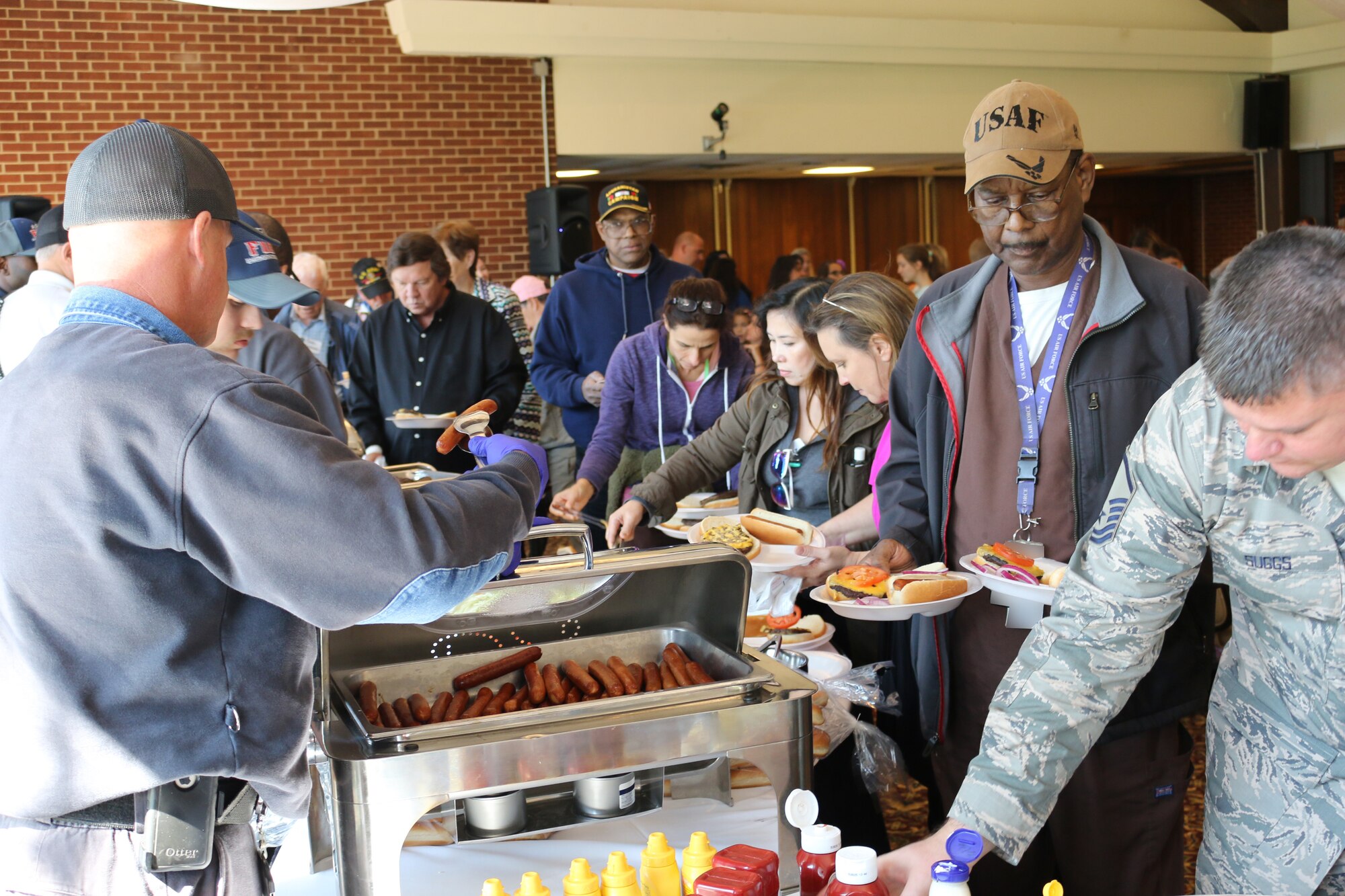 Past and present service members and their families line up for a free lunch during the Military Appreciation: Past, Present and Future Picnic, held Oct. 12 at Arnold Lakeside Center. (U.S. Air Force photo by Bradley Hicks) (This image was manipulated by obscuring badges for security purposes)