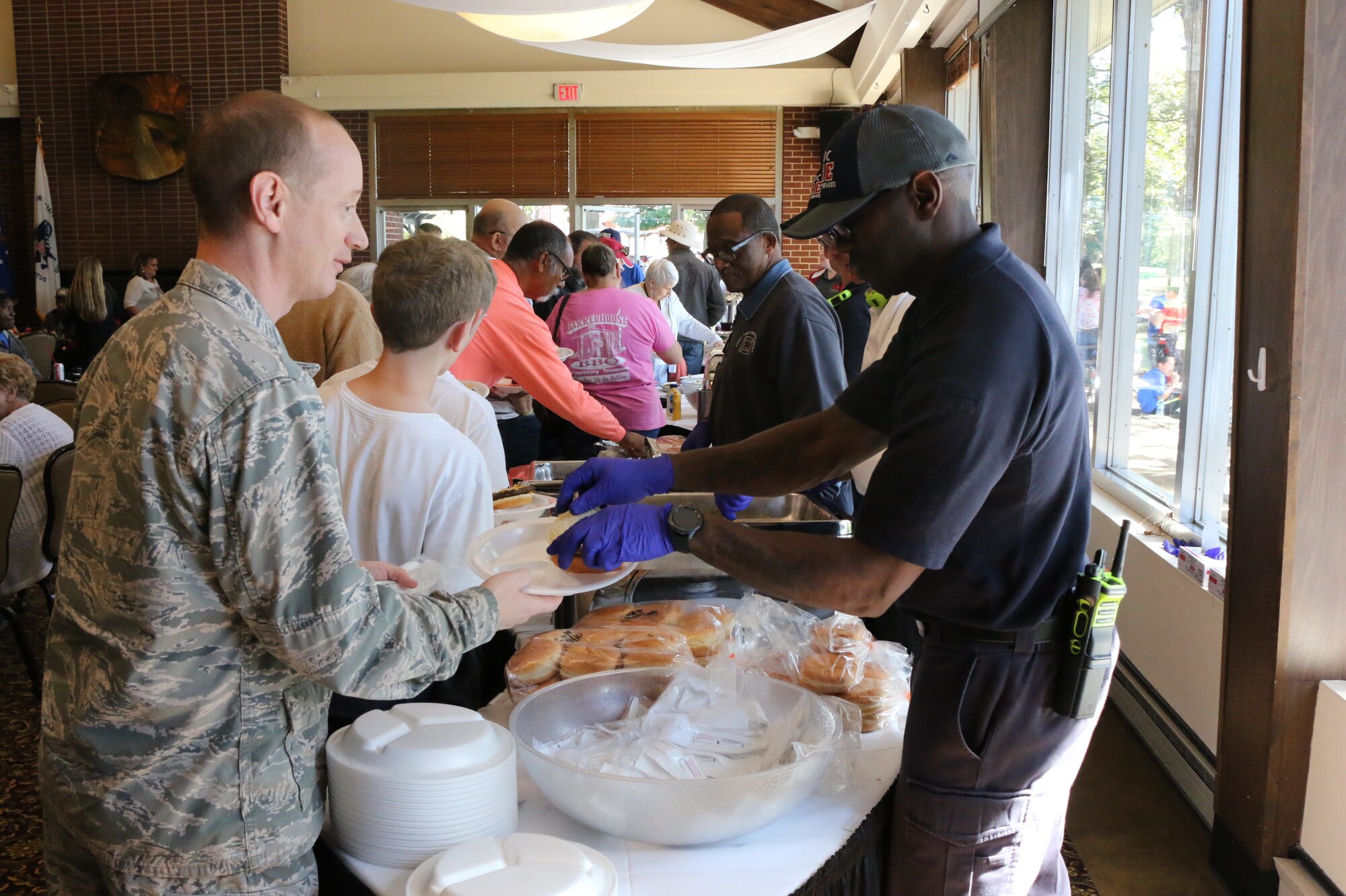 Lt. Col. Daniel Watson, Judge Advocate from Tyndall Air Force Base, left, receives his complimentary lunch from Arnold Air Force Base Fire and Emergency Services Driver/Operator Anthony Jimcoily during the Military Appreciation: Past, Present and Future Picnic, held Oct. 12 at Arnold Lakeside Center. The annual event is held to show appreciation to past and present service members and their families. Pictured to Jimcoily’s right is Arnold AFB firefighter Thomas King. (U.S. Air Force photo by Bradley Hicks)