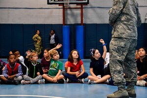 Kids from Joint Base Charleston raise their hands to answer questions about drug prevention Oct. 23, 2018 at the Joint Base Charleston, S.C., youth center.