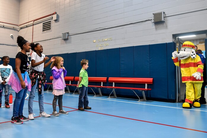 Joint Base Charleston youth center kids show excitement for Sparky the Fire Dog who made an appearance to give a pledge against drugs Oct. 23, 2018 at the youth center on Joint Base Charleston, S.C.. Sparky, along with the children, made a pledge to be drug-free in honor of Red Ribbon Week. As a part of the base’s efforts to take care of service members and their families, drug demand reduction program held several events to educate military youth.