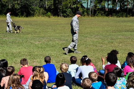 Kids from the Merrington Elementary School watch a K9 demonstration Oct. 29, 2018 at Joint Base Charleston, S.C.
