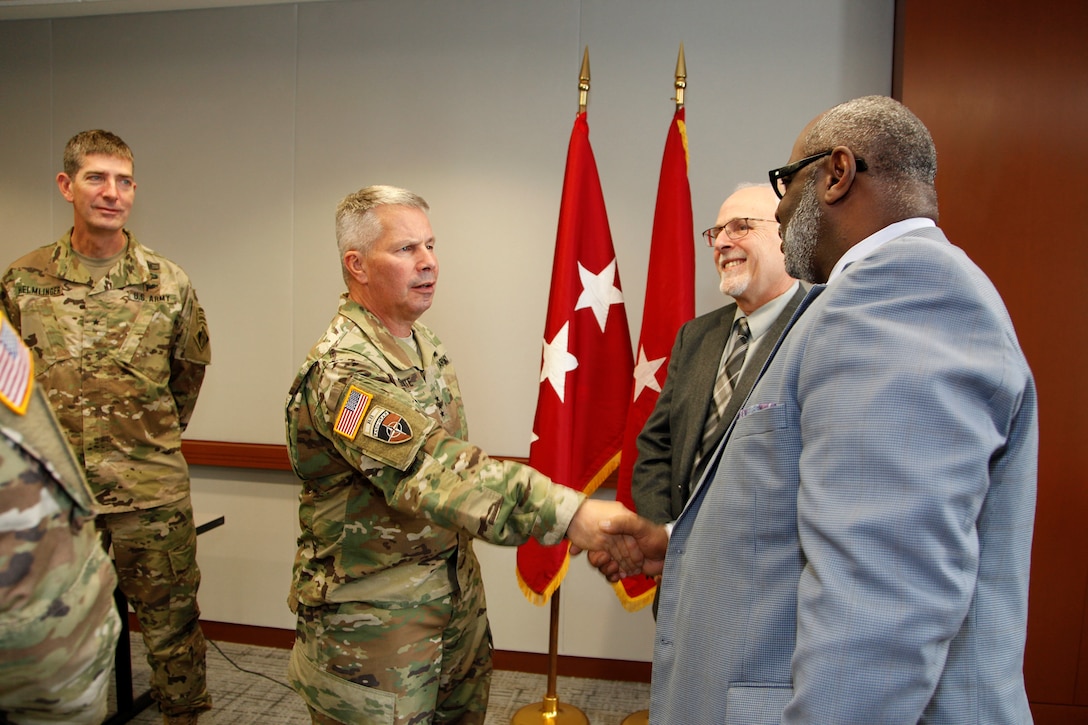 Lt. Gen. Todd Semonite, the 54th Chief of Engineers and Commanding General of the U.S. Army Corps of Engineers greeted Arthur Saulsberry, Small Business Deputy for the Kansas City District, as Northwestern Division Commander Brig. Gen. Pete Helmlinger, looks on after a Town Hall Meeting in Kansas City October 24, 2018. To the center and to the right of Lt. Gen. Semonite is Chief of the Kansas City District Construction Division, Bob Kreienheder.