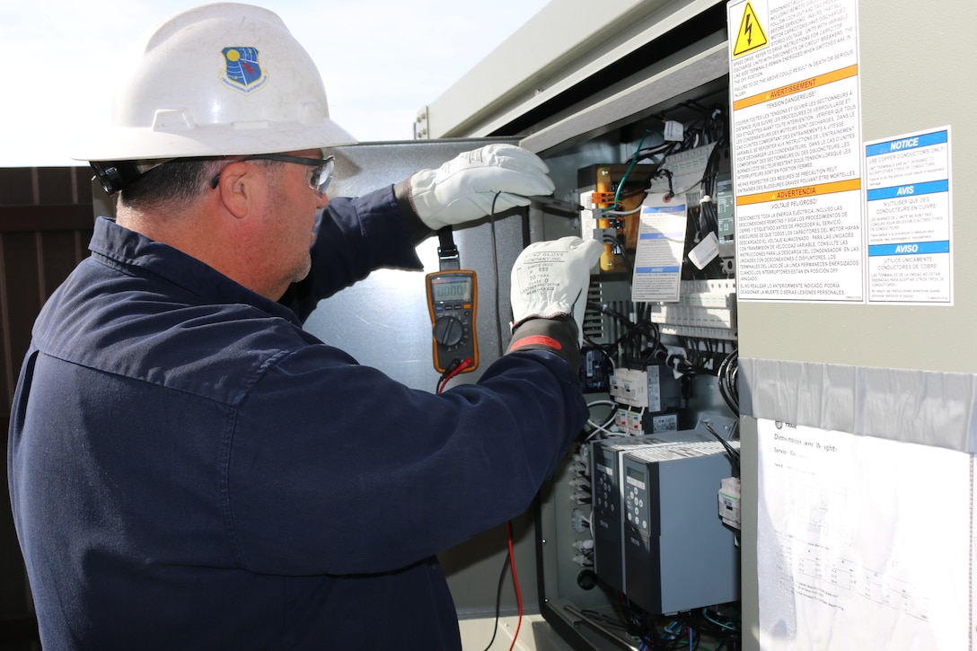 Duane Meadows, lead HVAC technician at Arnold Air Force Base, checks on an HVAC unit located outside of the Base Civil Engineering Building. (U.S. Air Force photo by Brad Hicks)