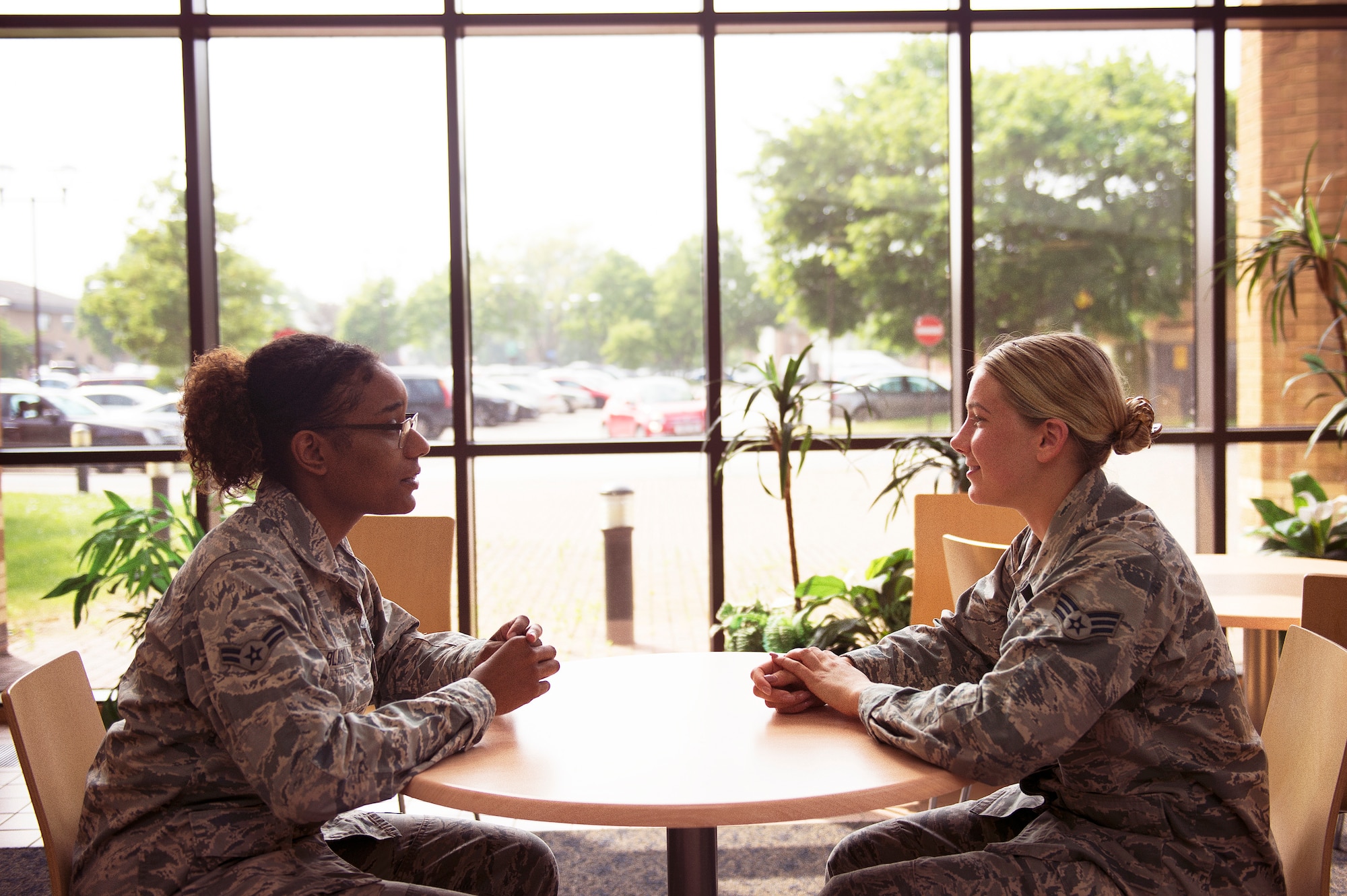 Airman 1st Class China Black (left) and Senior Airman Brianne Herklotz (right), mental health technicians, have a discussion at Royal Air Force Lakenheath, England. (U.S. Air Force photo/Airman 1st Class Shanice Williams-Jones)