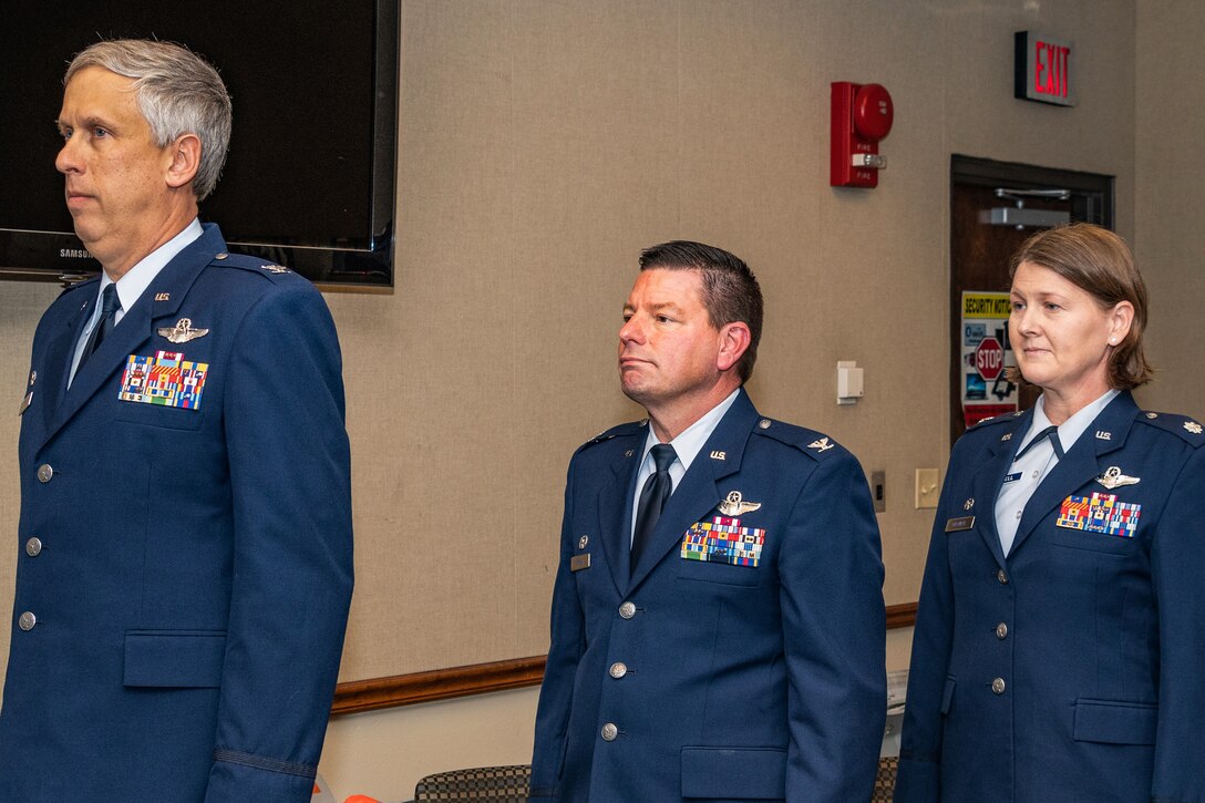 U.S. Air Force Col. Robert Burgess, Col. Shawn Werchan and Lt. Col. Joanna Mitchell stand at attention during a change of command ceremony for the 307th Operations Support Squadron at Barksdale Air Force Base, Louisiana, November 5, 2018.  Mitchell, who has more than 20 years of service in the Air Force, took command of the 307th OSS during the ceremony. (U.S. Air Force photo by Tech. Sgt. Cody Burt)