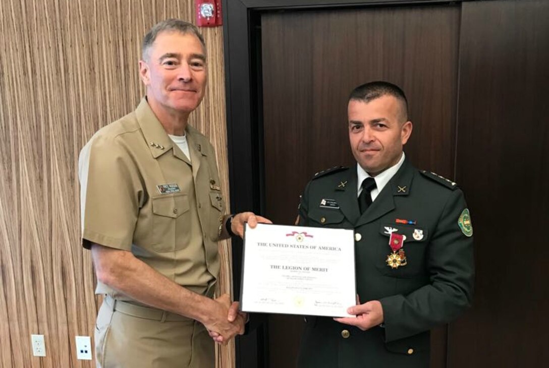 Col Chalabashvili receiving the US Legion of Merit award from NDU President Vice Admiral F.J. Roegge