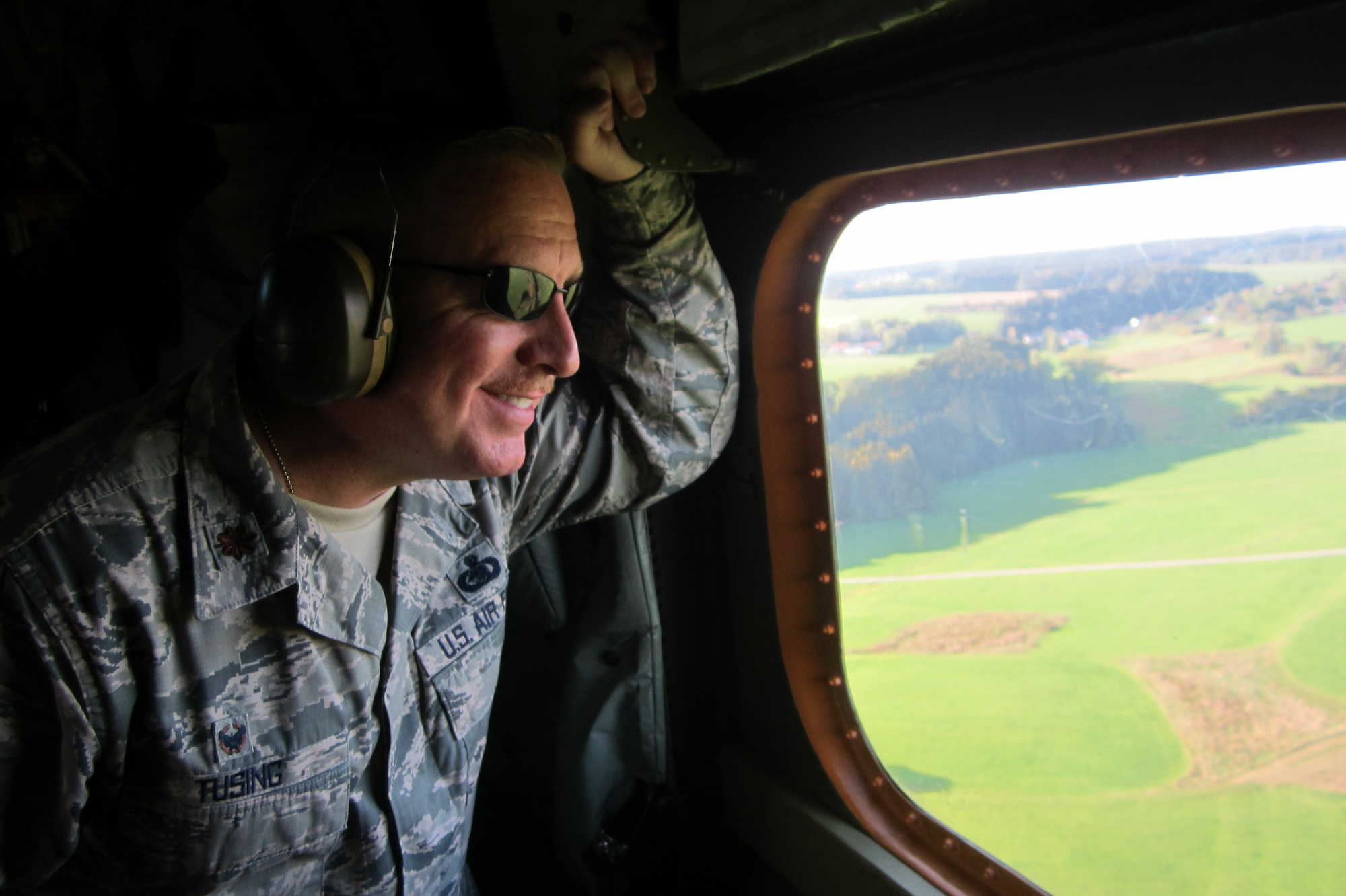 Maj. Christopher Tusing, 167th Logistics Readiness Squadron commander looks out a window of a CH-53 helicopter flying through Lech Valley to Füssen, Germany while visiting the country as part of the Military Reserve Exchange Program.