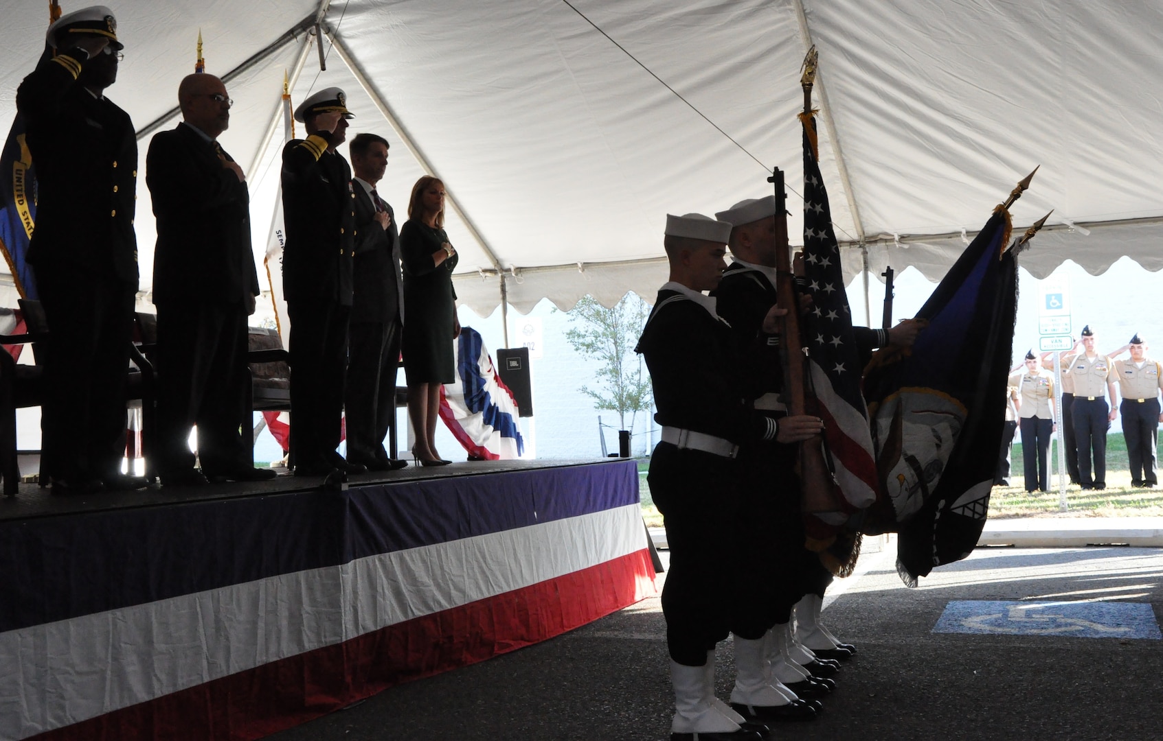 IMAGE: DAHLGREN, Va. (Nov. 1, 2018) – The Aegis Training and Readiness Center Ceremonial Color Guard presents colors during the national anthem at the ribbon-cutting ceremony for the Navy’s Missile Support Facility. In the background are King George High School Junior Reserve Officer Training Corps cadets while on stage stand the event’s guest speakers and the chaplain who gave the invocation. The facility features state-of-the-art labs, offices, and equipment for more than 300 NSWCDD Strategic and Computing Systems Department scientists, engineers, and technical experts who develop, test, and maintain the Submarine Launched Ballistic Missile fire control and mission planning software.