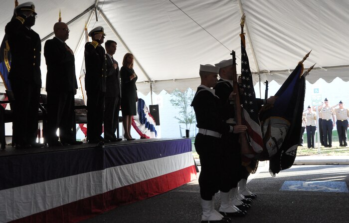 IMAGE: DAHLGREN, Va. (Nov. 1, 2018) – The Aegis Training and Readiness Center Ceremonial Color Guard presents colors during the national anthem at the ribbon-cutting ceremony for the Navy’s Missile Support Facility. In the background are King George High School Junior Reserve Officer Training Corps cadets while on stage stand the event’s guest speakers and the chaplain who gave the invocation. The facility features state-of-the-art labs, offices, and equipment for more than 300 NSWCDD Strategic and Computing Systems Department scientists, engineers, and technical experts who develop, test, and maintain the Submarine Launched Ballistic Missile fire control and mission planning software.