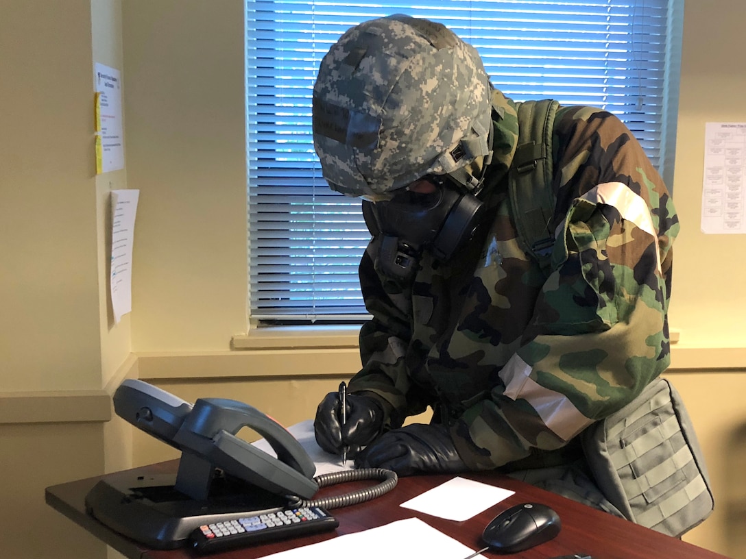 Airmen from the 104th Fighter Wing work in Mission Oriented Protective Posture level four Nov. 4, 2018, at Barnes Air National Guard Base, Massachusetts. The airmen kept morale high while working to enhance mission readiness.  (U.S. National Guard photo by 2Lt. Amelia Leonard. Cleared for public release)