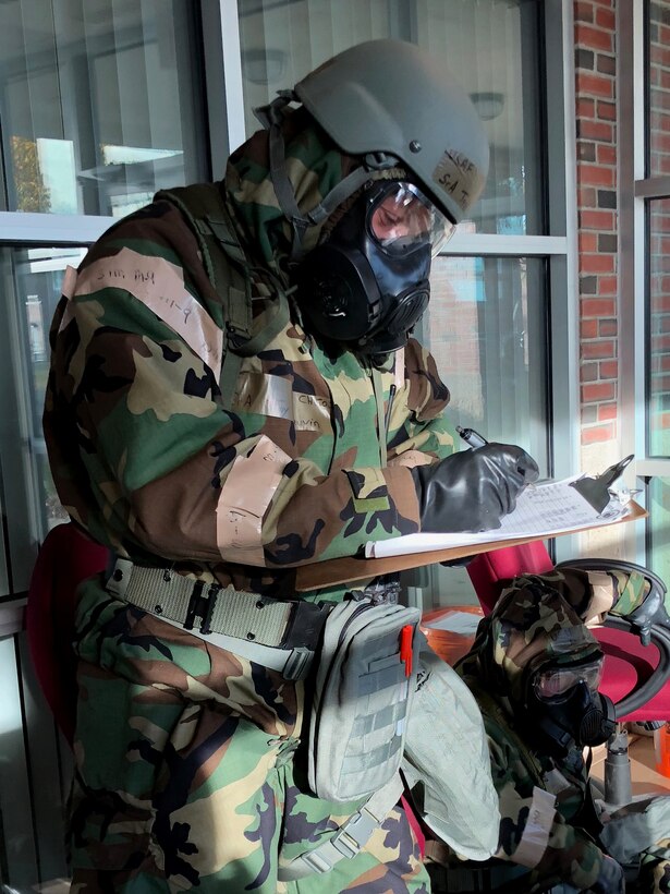 Airmen from the 104th Fighter Wing work in Mission Oriented Protective Posture level four Nov. 4, 2018, at Barnes Air National Guard Base, Massachusetts. The airmen kept morale high while working to enhance mission readiness.  (U.S. National Guard photo by 2Lt. Amelia Leonard. Cleared for public release)