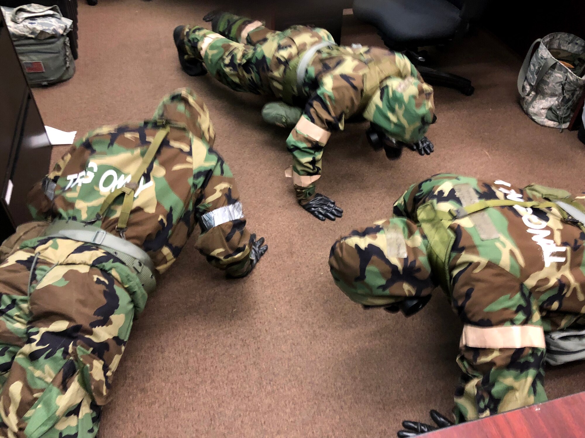 Airmen from the 104th Fighter Wing work in Mission Oriented Protective Posture level four Nov. 4, 2018, at Barnes Air National Guard Base, Massachusetts. The airmen kept morale high while working to enhance mission readiness.  (U.S. National Guard photo by 2Lt. Amelia Leonard. Cleared for public release)