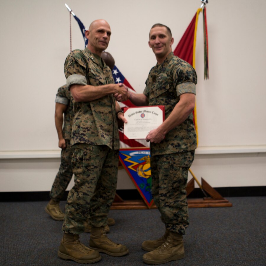 Maj. Gen. Kevin Iiams, commanding general of 3rd Marine Aircraft Wing, presents the senior Sailor of the quarter award to HM1 Kurtis Lett with, Marine Aircraft Group 16, at Marine Corps Air Station Miramar, Calif., Nov. 1, 2019. The ceremony recognized Marines and Sailors for their exceptional work ethic and achievements during 1st quarter of fiscal year 19. (U.S. Marine Corps photo by Cpl. Preston J. Hightower)