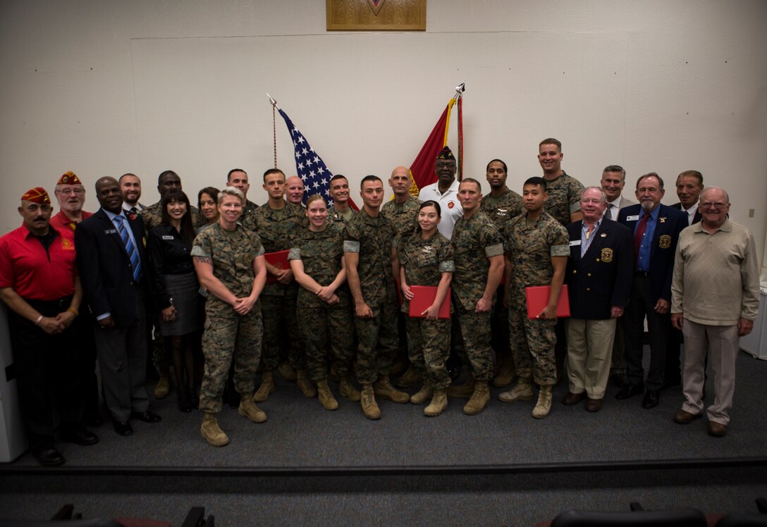 U.S. Marines, Sailors and civilians pose for a photo after an award ceremony at Marine Corps Air Station Miramar, Calif., Nov. 1, 2019. The ceremony recognized Marines and Sailors for their exceptional work ethic ad achievements during 1st quarter of fiscal year 19. (U.S. Marine Corps photo by Cpl. Preston J. Hightower)