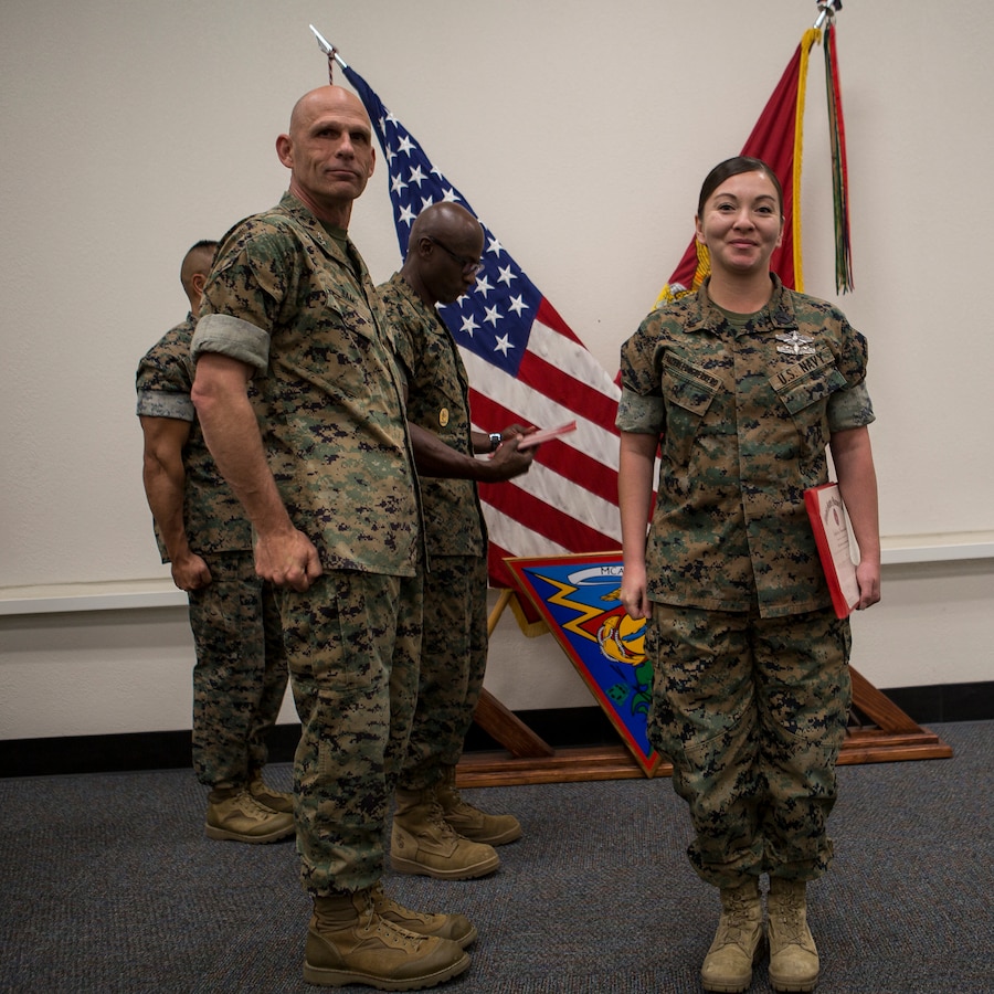 Maj. Gen. Kevin Iiams, commanding general of 3rd Marine Aircraft Wing, presents the junior sailor of the quarter award to HM2 Theresa Frazerleonguerrero with, Marine Air Control Group 38, at Marine Corps Air Station Miramar, Calif., Nov. 1, 2019. The ceremony recognized Marines and Sailors for their exceptional work ethic and achievements during 1st quarter of fiscal year 19. (U.S. Marine Corps photo by Cpl. Preston J. Hightower)