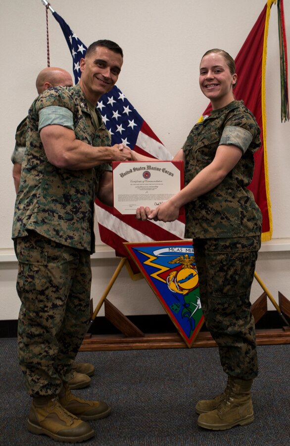 Col. Charles Dockery, commanding officer of Marine Corps Air Station (MCAS) Miramar presents the Marine of the quarter award to Lance Cpl. Destinee Folmar with, Headquarters & Headquarters Squadron, at MCAS Miramar, Calif., Nov. 1, 2019. The ceremony recognized Marines and Sailors for their exceptional work ethic and achievements during 1st quarter of fiscal year 19. (U.S. Marine Corps photo by Cpl. Preston J. Hightower)