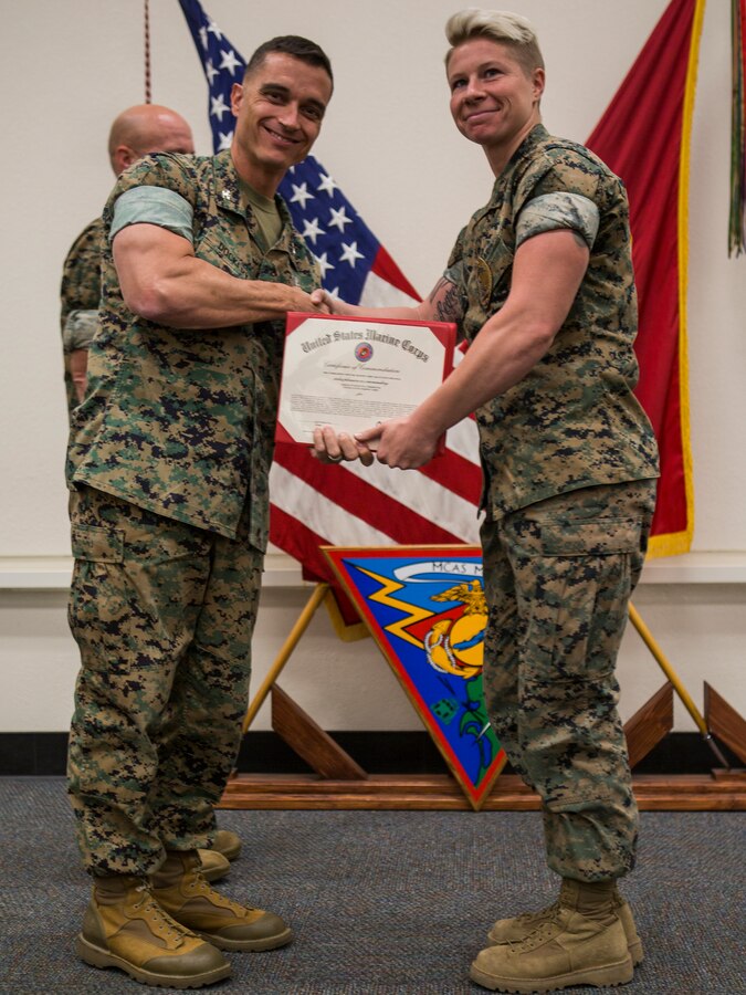 Col. Charles Dockery, commanding officer of Marine Corps Air Station (MCAS) Miramar presents the NCO of the quarter award to Sgt. Kaitlyn Fishbough, with the Provost Marshal's Office, at MCAS Miramar, Calif., Nov. 1, 2019. The ceremony recognized Marines and Sailors for their exceptional work ethic and achievements during 1st quarter of fiscal year 19. (U.S. Marine Corps photo by Cpl. Preston J. Hightower)