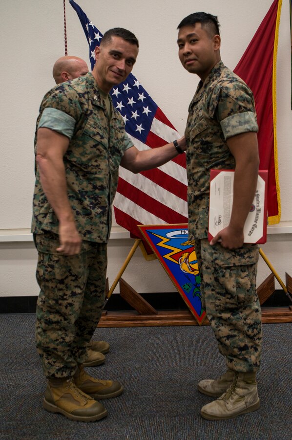 Col. Charles Dockery, commanding officer of Marine Corps Air Station (MCAS) Miramar presents the junior sailor of the quarter award to HM3 Jayapatrick Esguerra at MCAS Miramar, Calif., Nov. 1, 2019. The ceremony recognized Marines and Sailors for their exceptional work ethic and achievements during 1st quarter of fiscal year 19. (U.S. Marine Corps photo by Cpl. Preston J. Hightower)