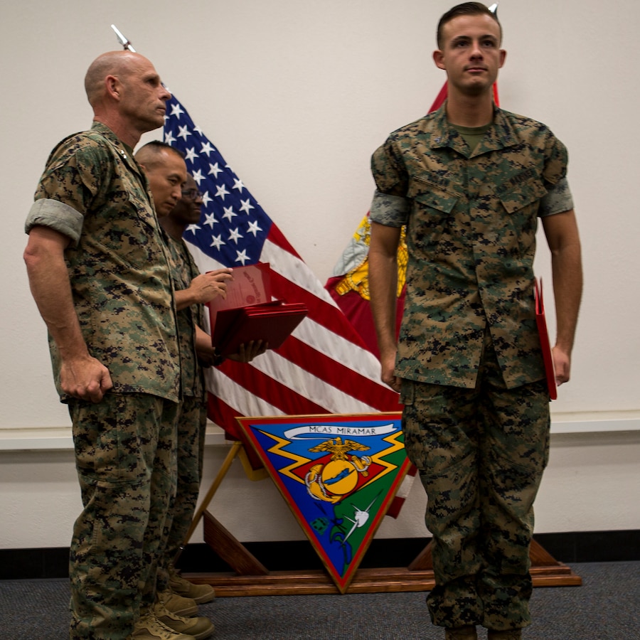 Maj. Gen. Kevin Iiams, commanding general of 3rd Marine Aircraft Wing,  presents the NCO of the quarter award to Cpl. Andrew Z. Dolan with, Marine Aircraft Group 11 at Marine Corps Air Station Miramar, Calif., Nov. 1, 2019. The ceremony recognized Marines and Sailors for their exceptional work ethic and achievements during 1st quarter of fiscal year 19. (U.S. Marine Corps photo by Cpl. Preston J. Hightower)