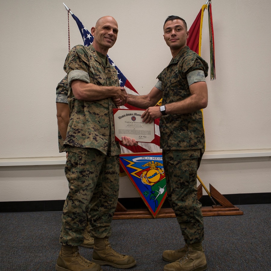 Maj. Gen. Kevin Iiams, commanding general of 3rd Marine Aircraft Wing, presents the Marine of the quarter award to Lance Cpl. Troy Deblock with, Marine Aviation Logistics Squadron, Marine Aircraft Group 39 at Marine Corps Air Station Miramar, Calif., Nov. 1, 2019. The ceremony recognized Marines and Sailors for their exceptional work ethic and achievements during 1st quarter of fiscal year 19. (U.S. Marine Corps photo by Cpl. Preston J. Hightower)