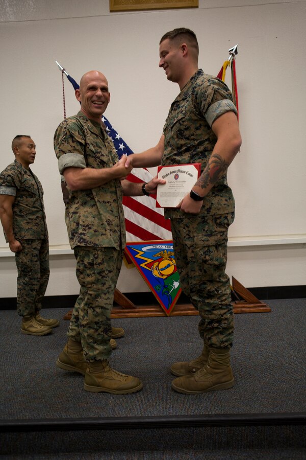 Maj. Gen. Kevin Iiams, commanding general of 3rd Marine Aircraft Wing, presents the bluejacket of the quarter award to HM3 Tristan Daniel with, Marine Aircraft Group 13 at Marine Corps Air Station Miramar, Calif., Nov. 1, 2019. The ceremony recognized Marines and Sailors for their exceptional work ethic and achievements during 1st quarter of fiscal year 19. (U.S. Marine Corps photo by Cpl. Preston J. Hightower