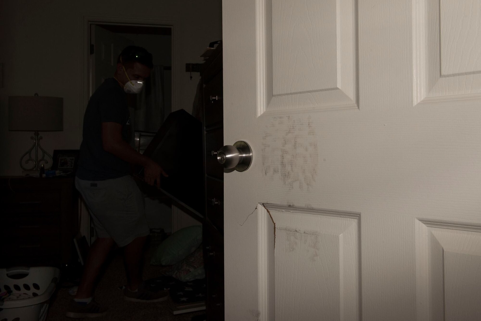 The Kriete's have help from a friend moving things out of their bedroom after having to kick open their bedroom door, at Tyndall Air Force Base, Fla., Oct. 19, 2018. Tyndall AFB was damaged by Hurricane Michael which displaced approximately 11,000 people, to include the Kriete family who travelled back to Tyndall during a five hour window to recover their belongings.