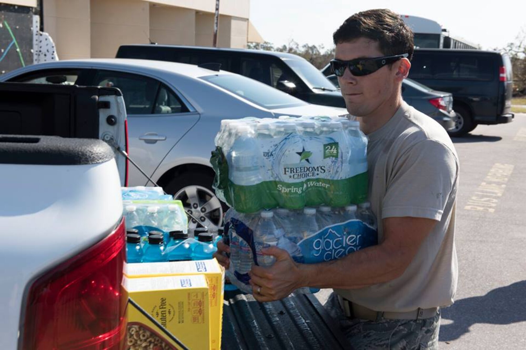 1st Lt. Adam Kriete, 337th Air Control Squadron student, delivers food and water to Tyndall AFB residents at the Youth Center at Tyndall Air Force Base Fla., Oct. 19, 2018. Tyndall AFB was damaged by Hurricane Michael which displaced approximately 11,000 people, to include the Kriete family who travelled back to Tyndall during a five hour window to recover their belongings.