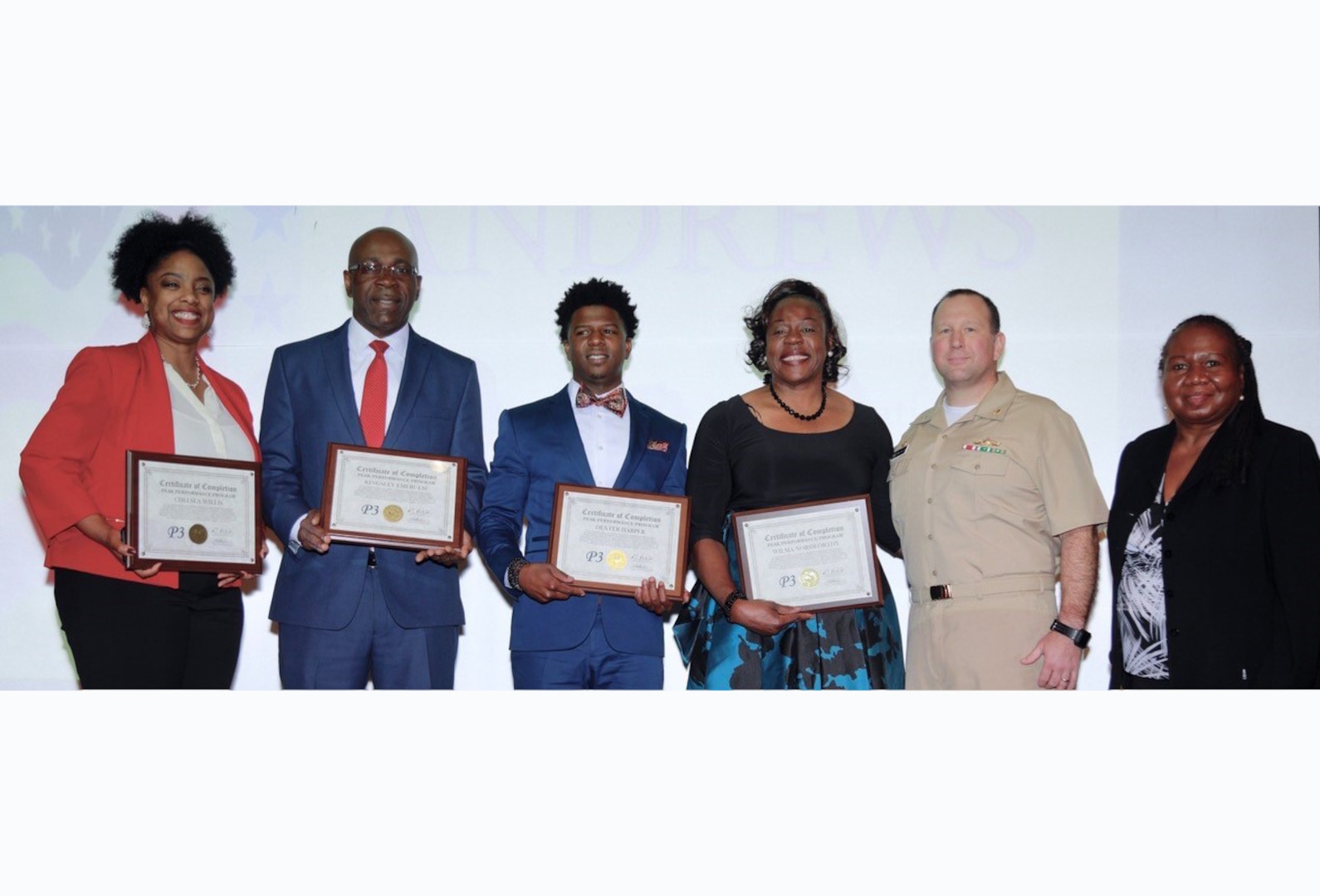 Group of men and women holding certificates