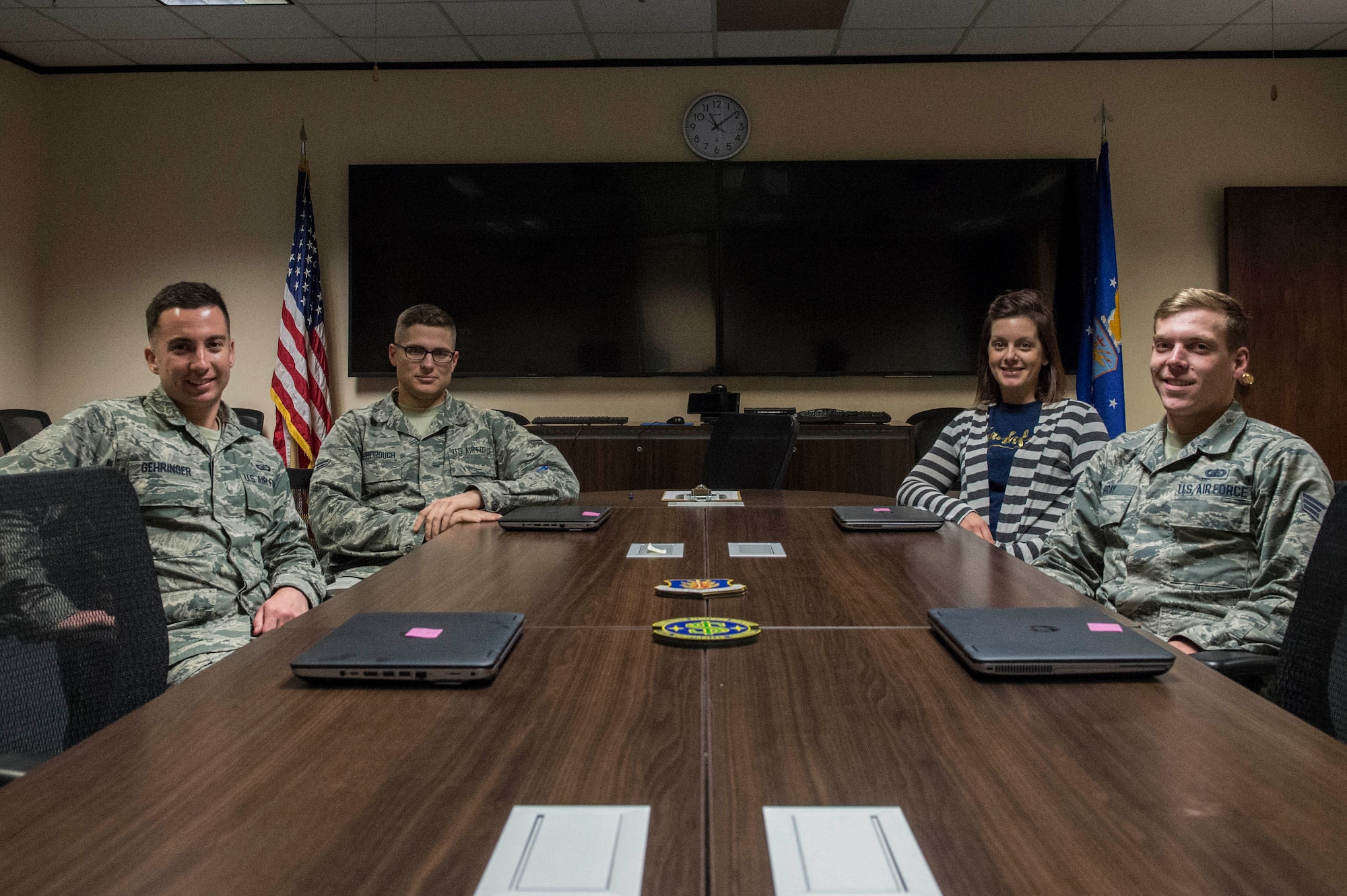 Members of the 97th Comptroller Squadron who help with the Defense Travel System Help Desk program, await members of the base who need assistance with DTS