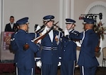 Five members of the Air Force Honor Guard Drill Team hold weapons at the ready to perform precision drill exercises to entertain the audience during the 2nd Annual DLA Ball.