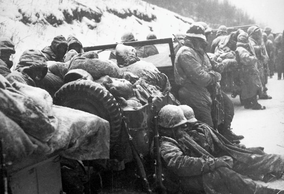 Astonished Marines of 5th and 7th Regiments, who hurled back surprise onslaught by three Chinese communist divisions, hear that they are to withdraw, circa December 1950 (U.S. Marine Corps/U.S. National Archives and Records Administration/Frank C. Kerr)