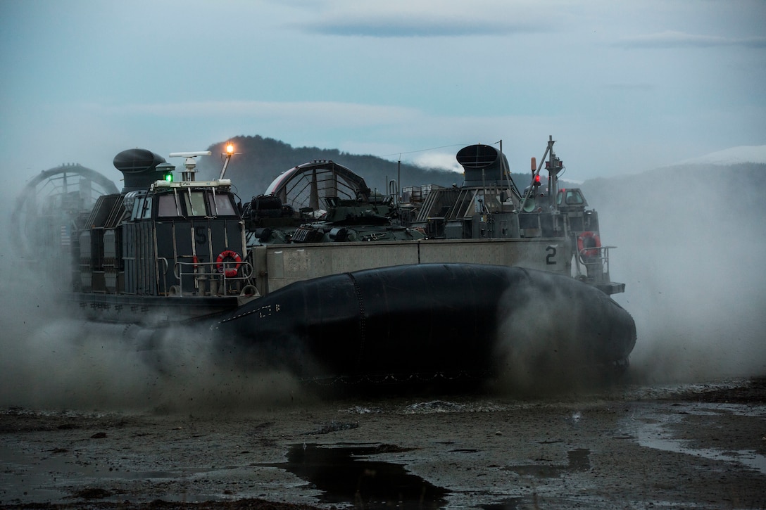 A landing craft air cushion lands on Alvund Beach, Norway during an amphibious landing in support of Trident Juncture 18, Oct. 30, 2018. Trident Juncture provides a unique and challenging environment for Marines and Sailors to rehearse their amphibious capabilities which will result in a more ready and proficient fighting force. The LCACs originated from USS New York (LPD 21) and showcased the ability of the Iwo Jima Amphibious Ready Group and the 24th Marine Expeditionary Unit to rapidly project combat power ashore. (U.S. Marine Corps photo by Lance Cpl. Margaret Gale)