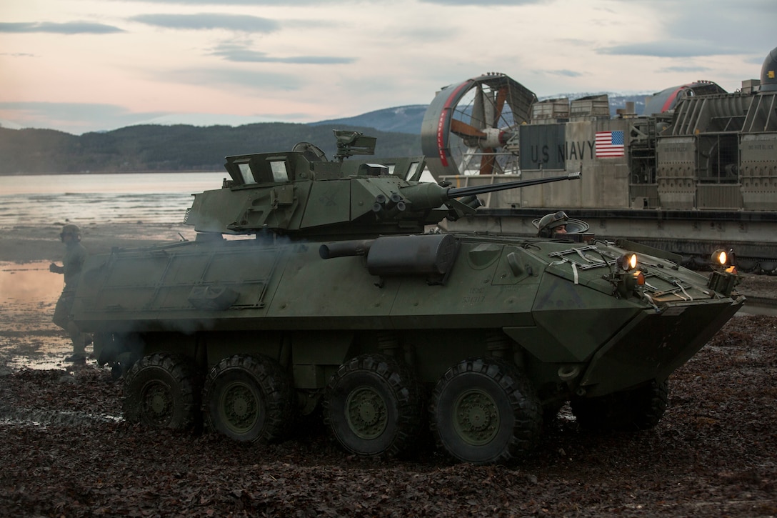 A light armored vehicle drives on Alvund Beach, Norway after disembarking a landing craft air cushion during an amphibious landing in support of Trident Juncture 18, Oct. 30, 2018.