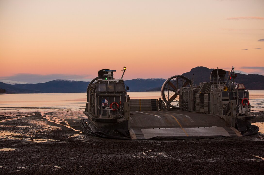 A landing craft air cushion rests on Alvund Beach after supporting an amphibious landing in during Trident Juncture 18 on Alvund Beach, Norway, Oct. 30, 2018. Trident Juncture provides a unique environment for the Marines and Sailors to rehearse their amphibious capabilities. The LCACs originated from USS New York (LPD 21) and showcased the ability of the Iwo Jima Amphibious Ready Group and the 24th Marine Expeditionary Unit to rapidly project combat power ashore. (U.S. Marine Corps photo by Lance Cpl. Margaret Gale)