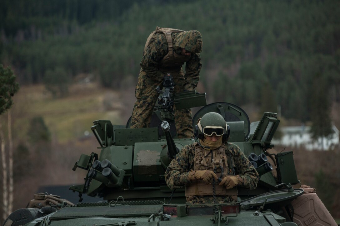 Marines prepare equipment on a light armored vehicle at Alvund Beach, Norway during an amphibious landing in support of Trident Juncture 18, Oct. 30, 2018. Trident Juncture provides a unique environment for the Marines and Sailors to rehearse their amphibious capabilities. The LAVs originated from USS New York (LPD 21) and showcased the ability of the Iwo Jima Amphibious Ready Group and the 24th Marine Expeditionary Unit to rapidly project combat power ashore. The Marines are with 2nd Light Armored Reconnaissance Battalion, 24th MEU. (U.S. Marine Corps photo by Lance Cpl. Margaret Gale)