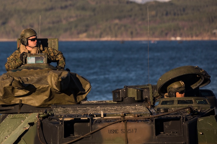 Marines prepare equipment on a light armored vehicle at Alvund Beach, Norway during an amphibious landing in support of Trident Juncture 18, Oct. 30, 2018.