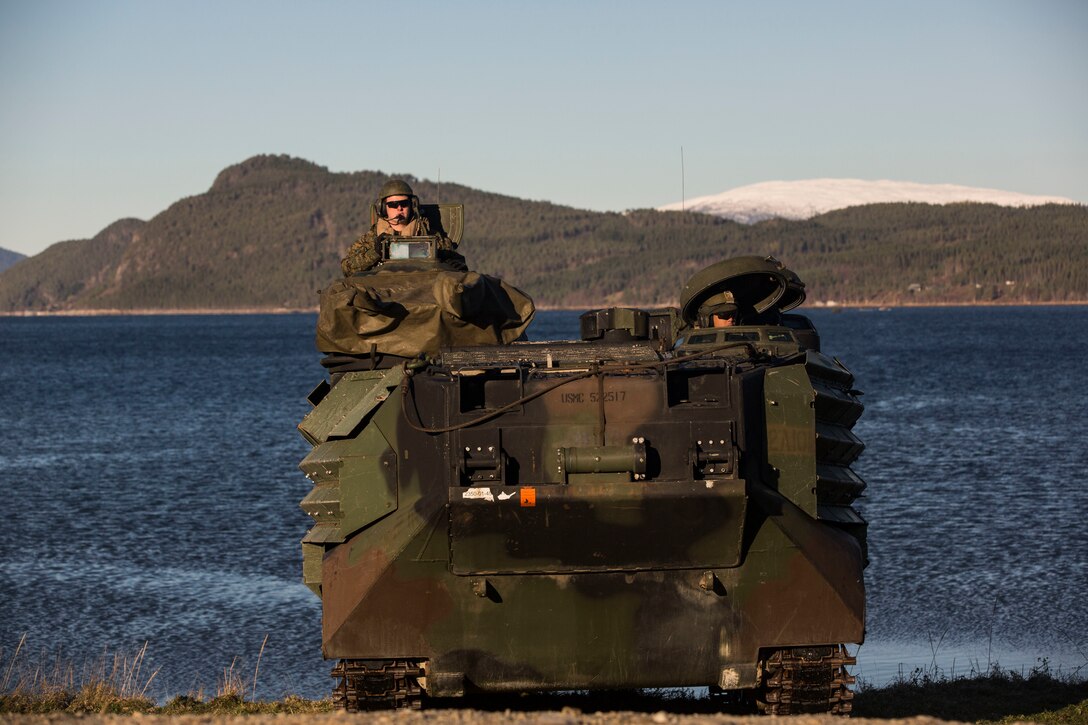 Amphibious assault vehicles come ashore during an amphibious landing in support of Trident Juncture 18 on Alvund Beach, Norway, Oct. 30, 2018. Trident Juncture provides a unique environment for the Marines and Sailors to rehearse their amphibious capabilities which will produce a more capable expeditionary fighting force. The AAVs originated from USS New York (LPD 21) and showcased the ability of the Iwo Jima Amphibious Ready Group and the 24th Marine Expeditionary Unit to rapidly project combat power ashore. The vehicles are with 2nd Amphibious Assault Battalion, 24th MEU. (U.S. Marine Corps photo by Lance Cpl. Margaret Gale)