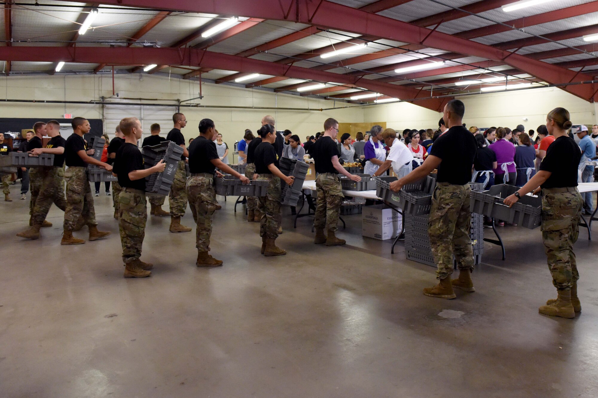 Soldiers from Goodfellow Air Force Base fill trays with food during the Feast of Sharing at the Wells Fargo Pavilion in San Angelo, Texas, Nov. 4, 2018. Goodfellow members volunteered their time for the local event. (U.S. Air Force photo by Senior Airman Randall Moose/Released)