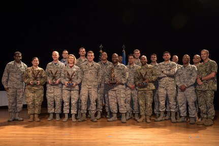 Col. Terrence Adams, left, 628th Air Base Wing commander and Command Master Chief Jonathan Lonsdale, right, Naval Support Activity Charleston command master chief, stand with the third quarter award winners Nov. 2, 2018, at the Air Base Theater. The ceremony recognized Airmen, NCOs, Senior NCOs, company grade officers, field grade officers and civilians on their hard work, dedication and superior performance.