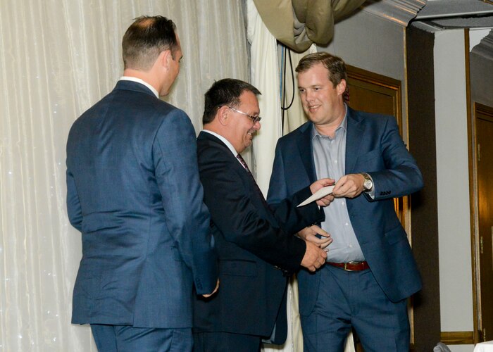 Tom Backmeyer, Lancaster JetHawks Executive Vice President, presents a check for $2,500 to Edwards Air Force Base Civilian-Military Support Group president, Allen Hoffman and David Norris, treasurer, during their Annual Installation of Officers and Directors dinner banquet at the University of Antelope Valley in Lancaster, California, Nov. 2. (U.S. Air Force photo by Giancarlo Casem)