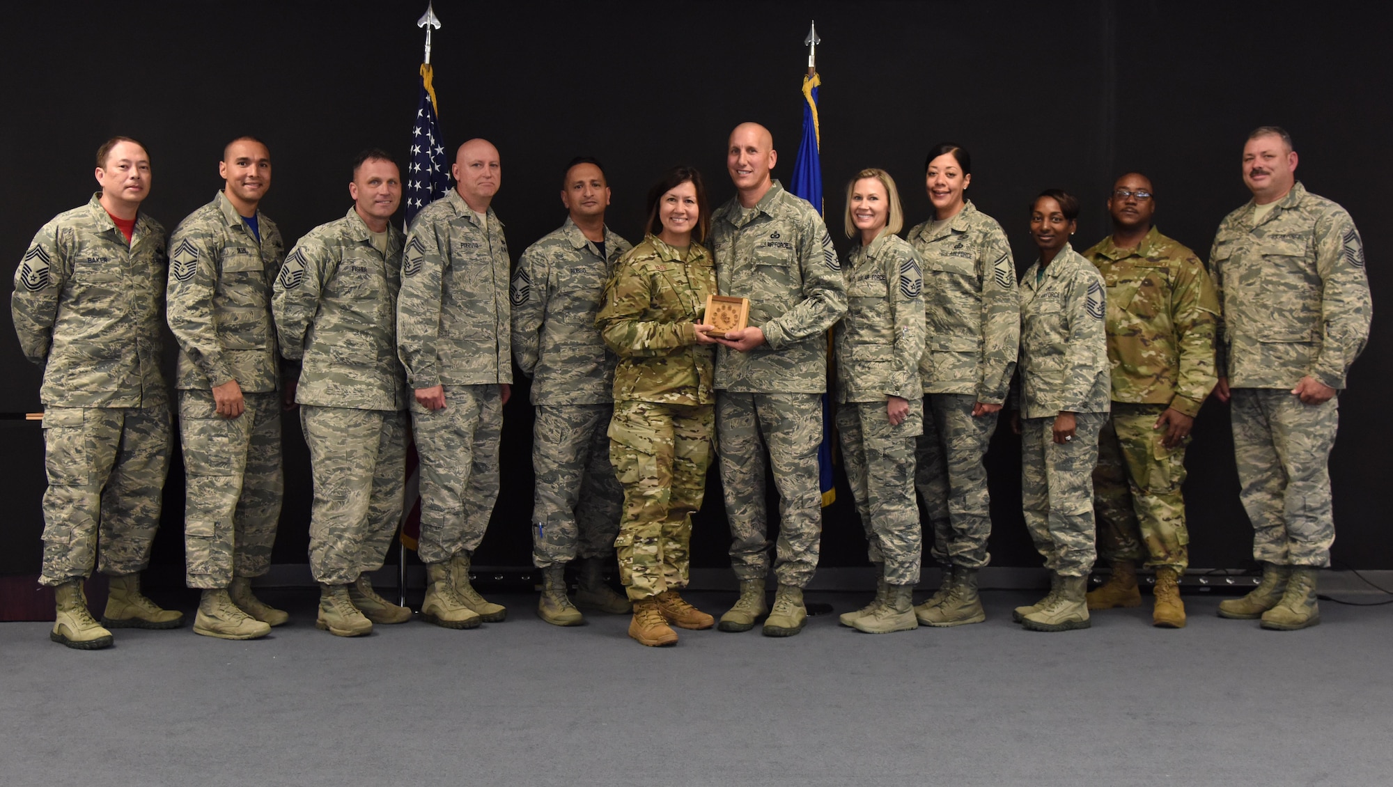U.S. Air Force Chief Master Sgt. JoAnne Bass, 2nd Air Force command chief, is joined by Keesler chief master sergeants to present Chief Master Sgt. Kenneth Carter, 81st Training Wing command chief, with a momento during his retirement farewell reception at Keesler Air Force Base, Mississippi, Nov. 2, 2018. Carter retired with more than 29 years of military service. (U.S. Air Force photo by Kemberly Groue)