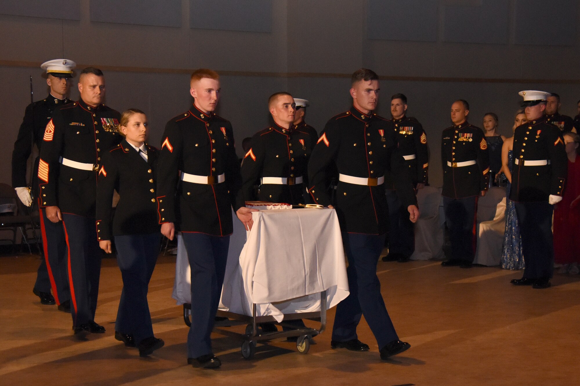 Members of Marine Corps Detachment at Goodfellow present the official birthday cake during the Marine Corps Ball at the McNease Convention Center, San Angelo, Texas, Nov. 2, 2018. The birthday cake is presented to the commanding officer to cut, the first piece given to the guest of honor and the second passed from the oldest serving Marine to the youngest serving Marine in attendance, representing the passing of knowledge. (U.S. Air Force photo by Airman 1st Class Seraiah Hines/Released)