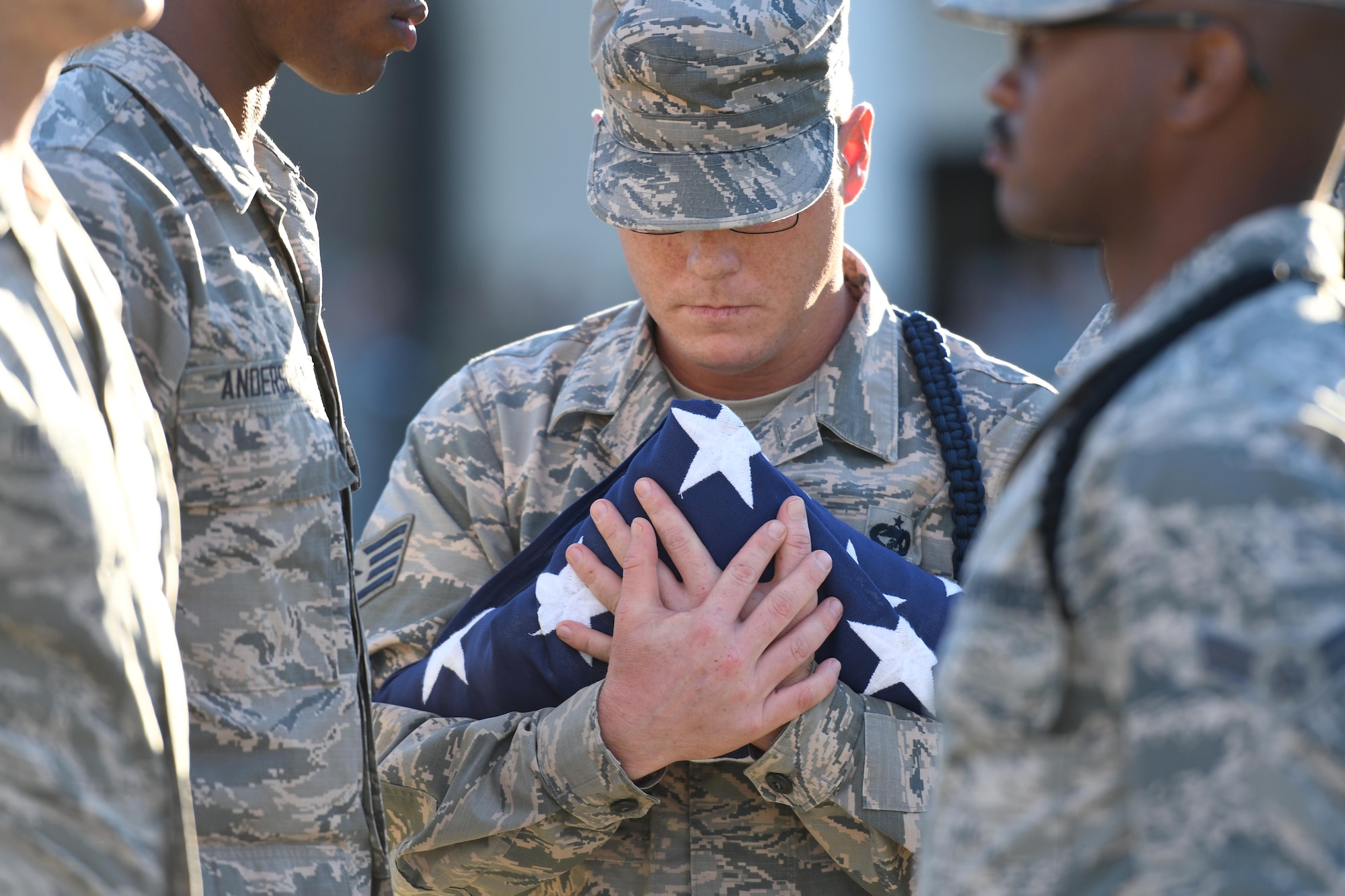 U.S. Air Force Staff Sgt. Travis Rayman, 336th Training Squadron military training leader, participates in folding the U.S. Flag during a retreat ceremony at Keesler Air Force Base, Mississippi, Nov. 2, 2018. The ceremony was held in honor of Chief Master Sgt. Kenneth Carter, 81st Training Wing command chief, who retired with more than 29 years of military service. (U.S. Air Force photo by Kemberly Groue)