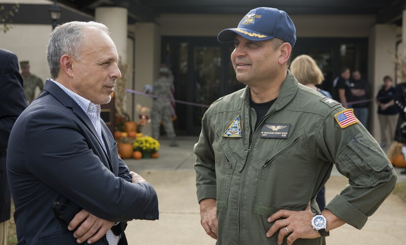 U.S. Navy Capt. Muhammad Khan, Joint Base McGuire-Dix-Lakehurst deputy commander, talks to an Honorary Commander during a ceremony marking the reopening of the Flight Deck on Joint Base MDL, New Jersey, Nov. 1, 2018. The ceremony was attended by service members and local community members and offers an alternate location for people to use as a recreational center. (U.S. Air Force photo by Airman 1st Class Ariel Owings)